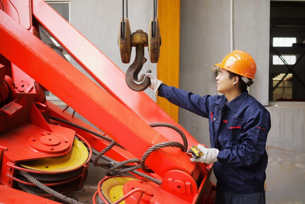 worker-using-equipment-in-crane-manufacturing-facility-china.jpg